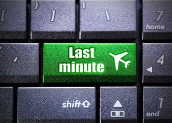 Cheap last-minute flight concept symbolized by a bright green keyboard button.