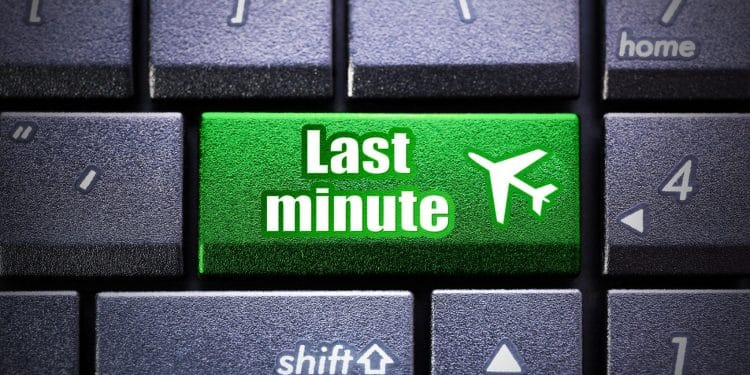 Cheap last-minute flight concept symbolized by a bright green keyboard button.