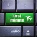 Cheap last-minute flight concept symbolized by a bright green keyboard button.