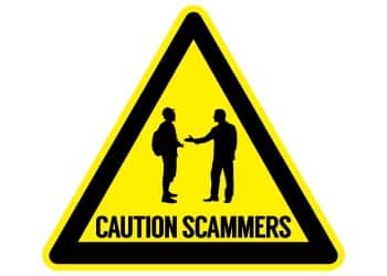 Warning sign depicting a scam interaction, representing common tourist traps travelers should avoid.