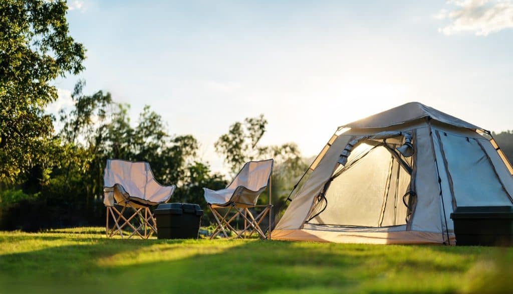 Tranquil camping scene at sunset, perfect for travelers seeking peaceful places to visit in nature.