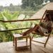 Woman enjoying a peaceful tropical view while sipping coconut water—one of the most peaceful places to visit.
