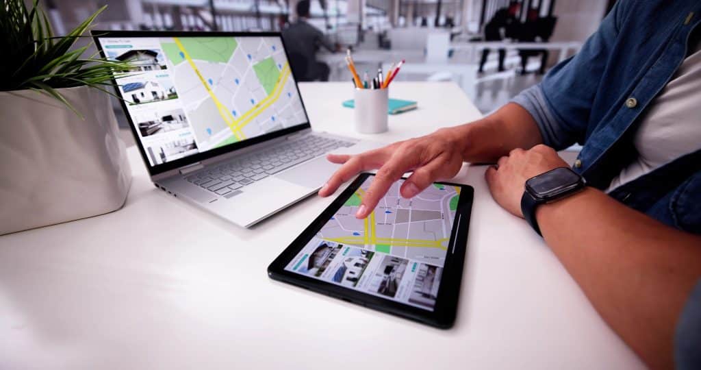 Traveler browsing maps and rental listings online to compare the best Airbnb alternatives before booking.