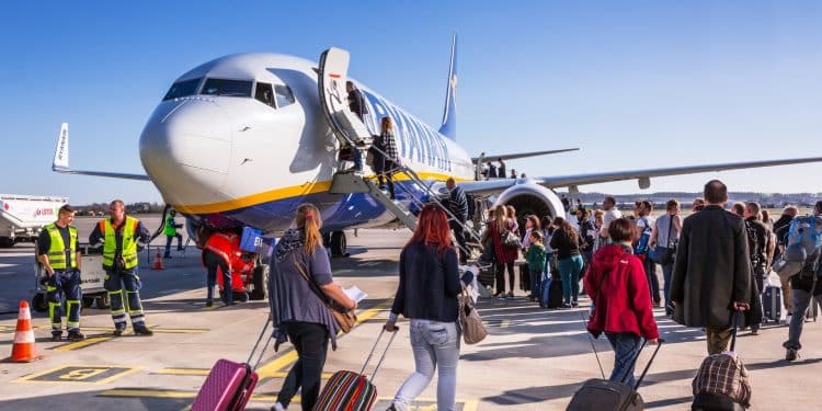 Travelers boarding a budget airline flight at the airport, highlighting the best budget airlines 2025 for affordable global travel.