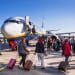 Travelers boarding a budget airline flight at the airport, highlighting the best budget airlines 2025 for affordable global travel.