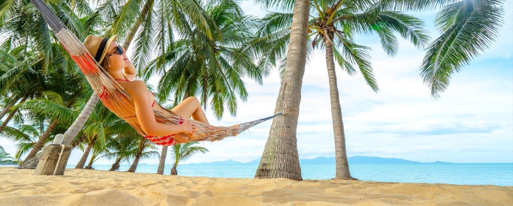 Relaxing in a hammock under palm trees on a quiet beach, best Philippine islands escape.