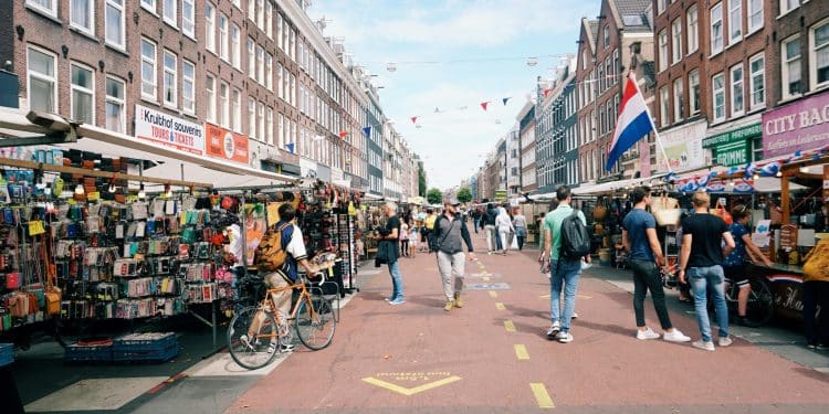 A lively street market scene with people walking around, perfect for finding cheap food in Europe.