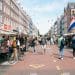 A lively street market scene with people walking around, perfect for finding cheap food in Europe.