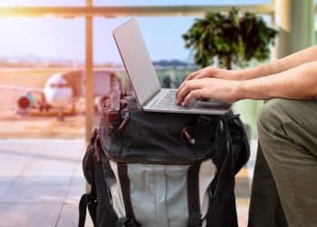 Traveler using portable office gear at airport.
