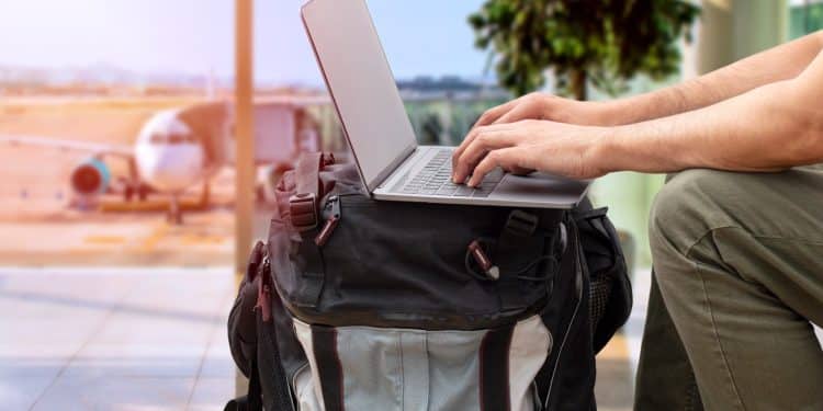 Traveler using portable office gear at airport.