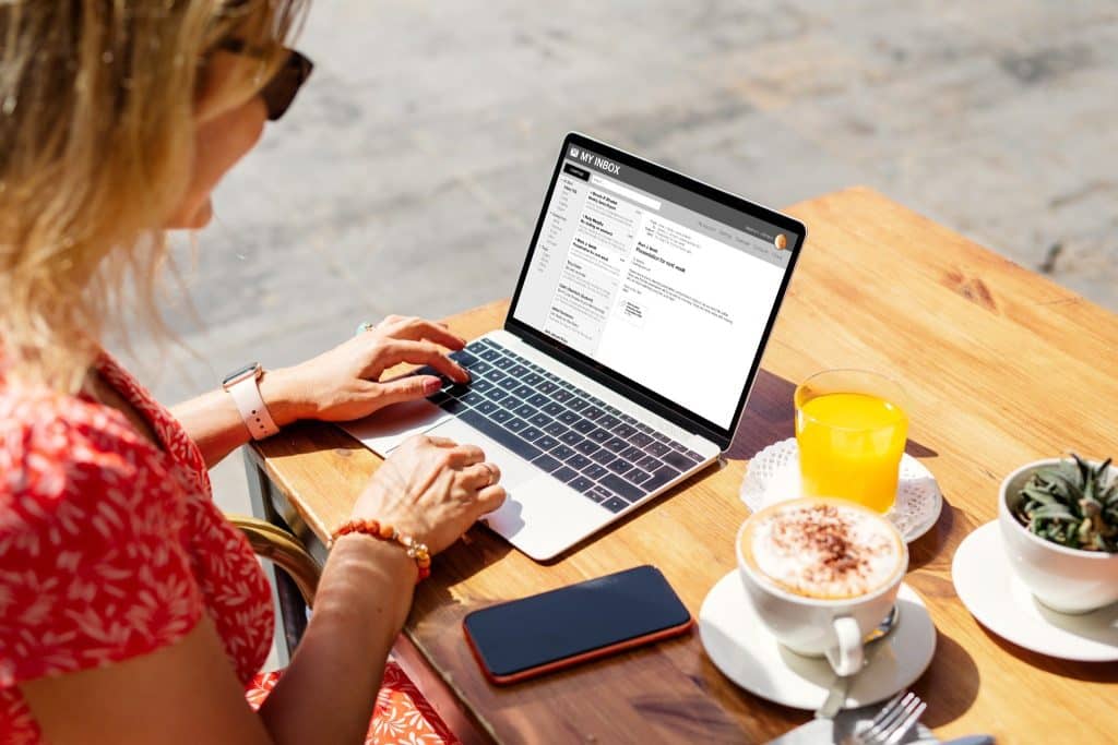 Freelancer woman using portable office gear at outdoor cafe.
