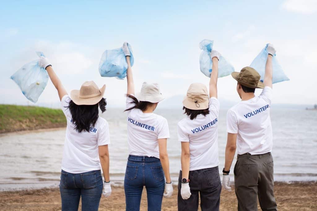 Beach cleanup team joining volunteer travel programs.