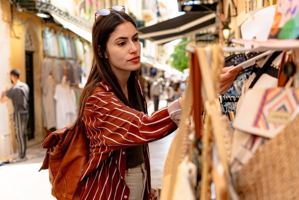 Traveler holding small souvenirs before fitting them into her bag