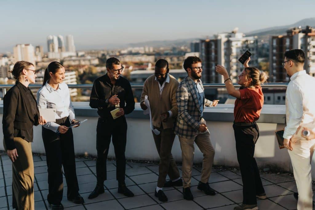 multicultural group enjoying rooftop view, coliving for digital nomads