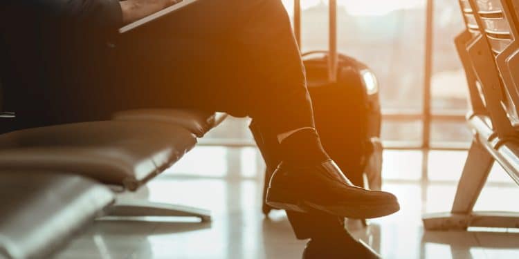 Business traveler on laptop in airport lounge