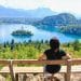 Traveler admiring Lake Bled travel with island in the distance.