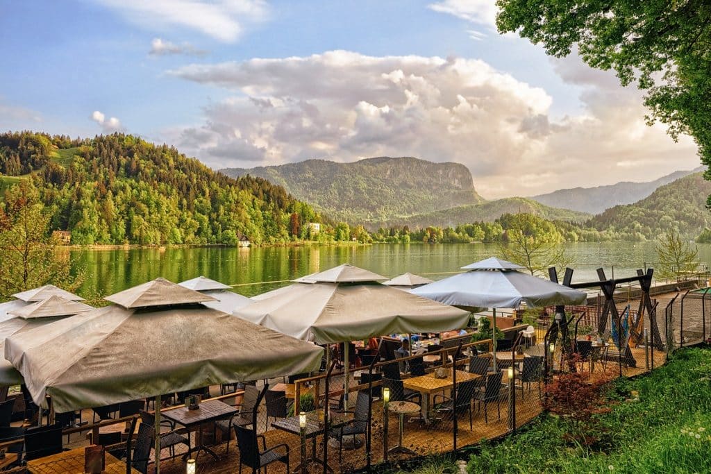 Lakeside café terrace during Lake Bled travel in summer.