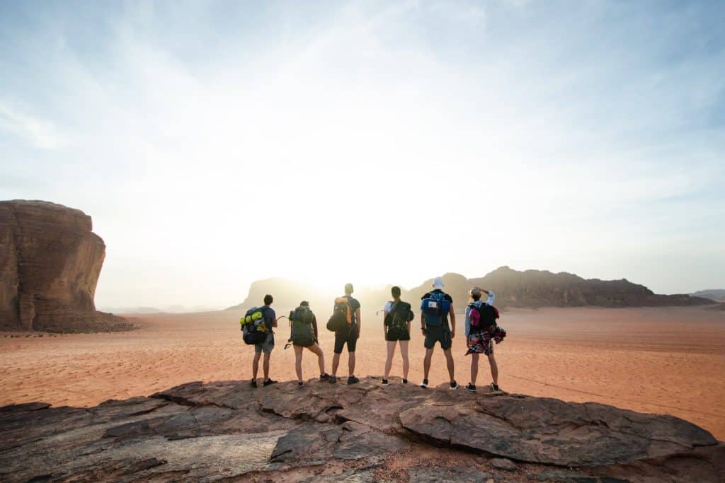 Backpackers exploring desert on Middle East travel budget