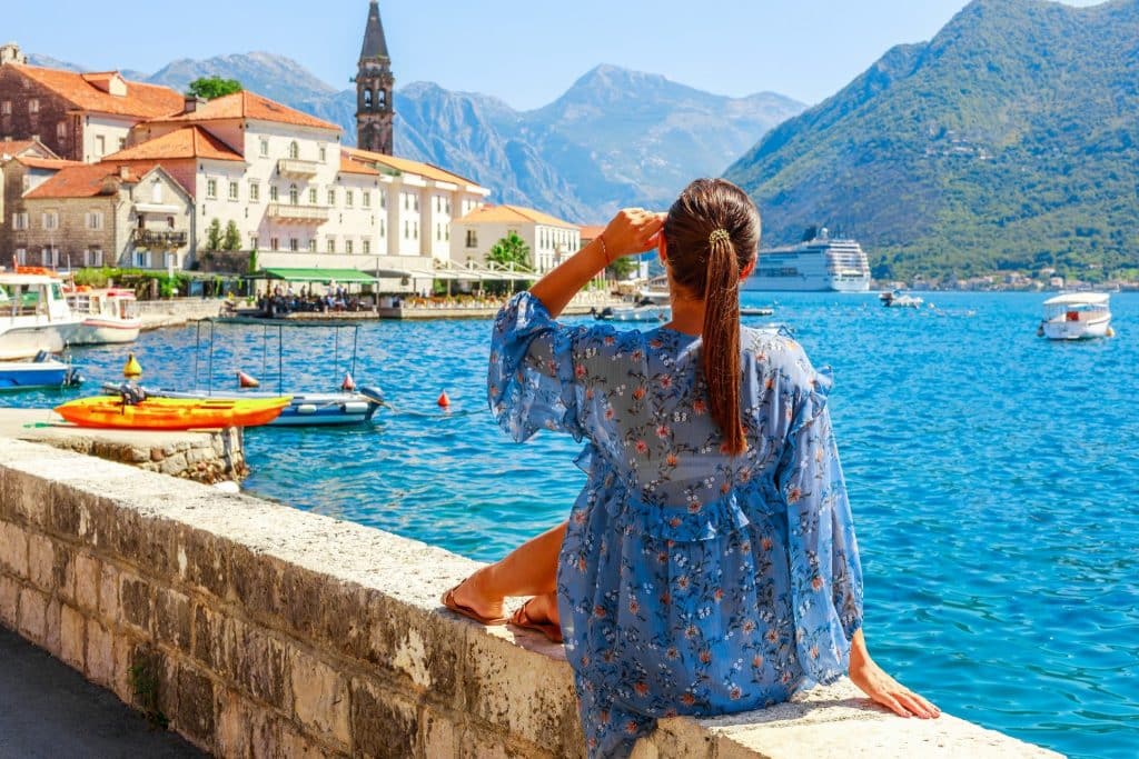 Woman relaxing by the Bay of Kotor during Montenegro travel