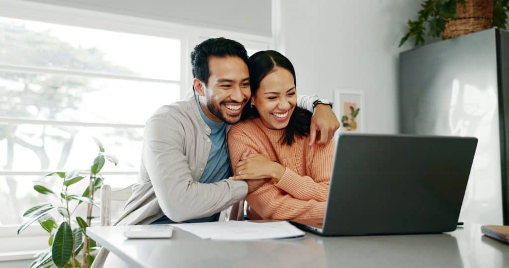 Couple reviewing paperwork on laptop for portugal digital nomad visa 2025 application