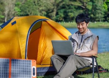 digital nomad working remotely on a lakeside in lisbon on D8 visa