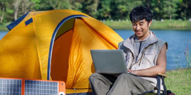 digital nomad working remotely on a lakeside in lisbon on D8 visa