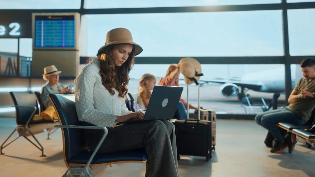 Digital nomad working in airport lounge on self transfer flights