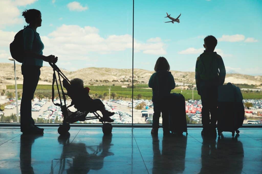 Family with stroller watching planes before self transfer flights
