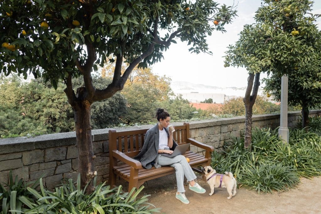 Remote worker in Spain park with laptop and coffee spain digital nomad visa requirements