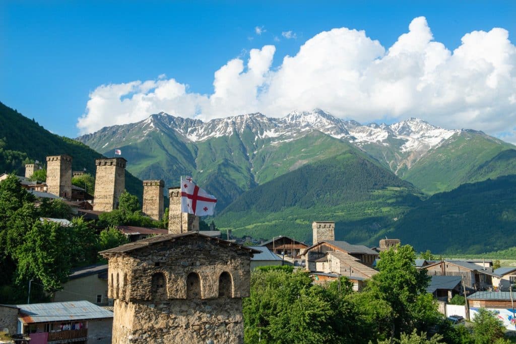 Georgian towers with mountains in background svaneti travel guide