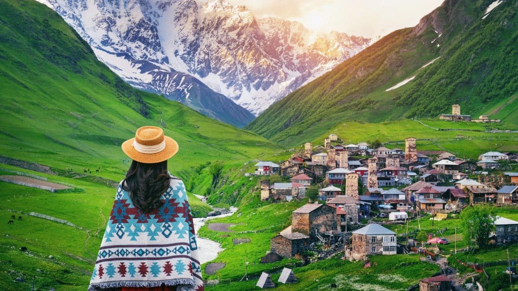 traveler looking at Ushguli village with mountains svaneti travel guide