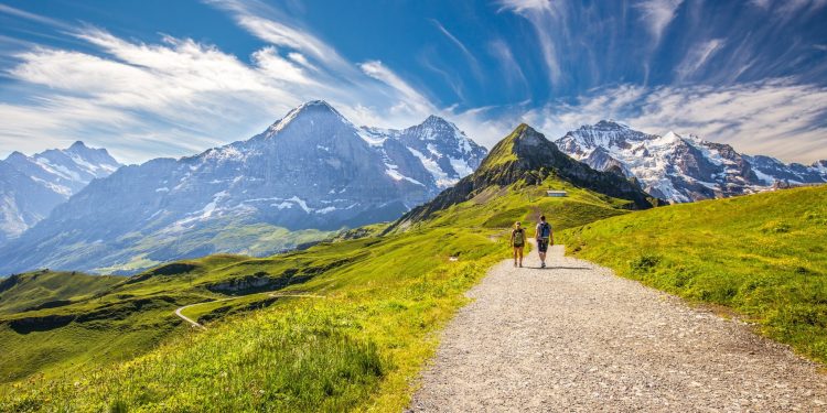 Hikers on Swiss alpine trail, swiss mountain huts guide