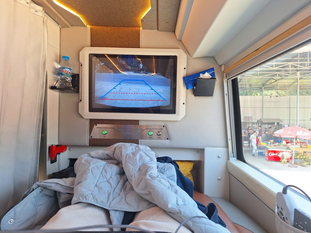Sleeper bus seat with blanket