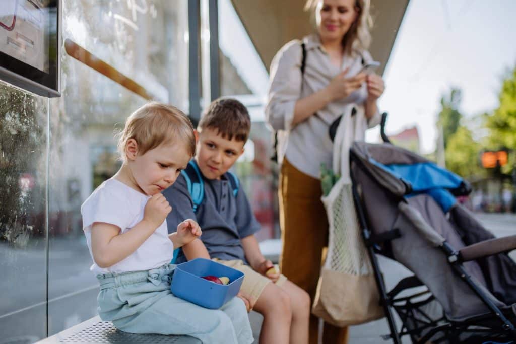 Mother with kids at bus stop