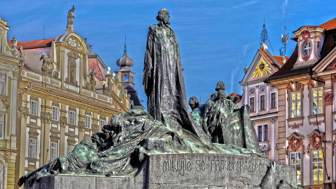 a statue in front of a building in a city