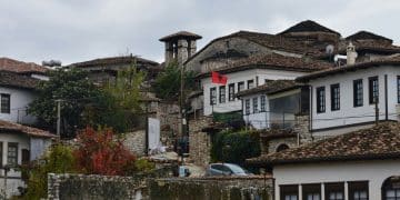 White houses with tiled roofs on a hill.